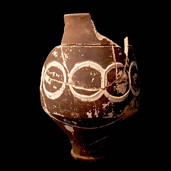 Broken ceramic vase displayed in museum